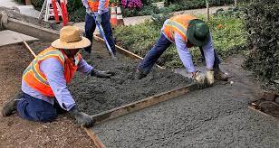 Worker do sidewalk installation in NYC