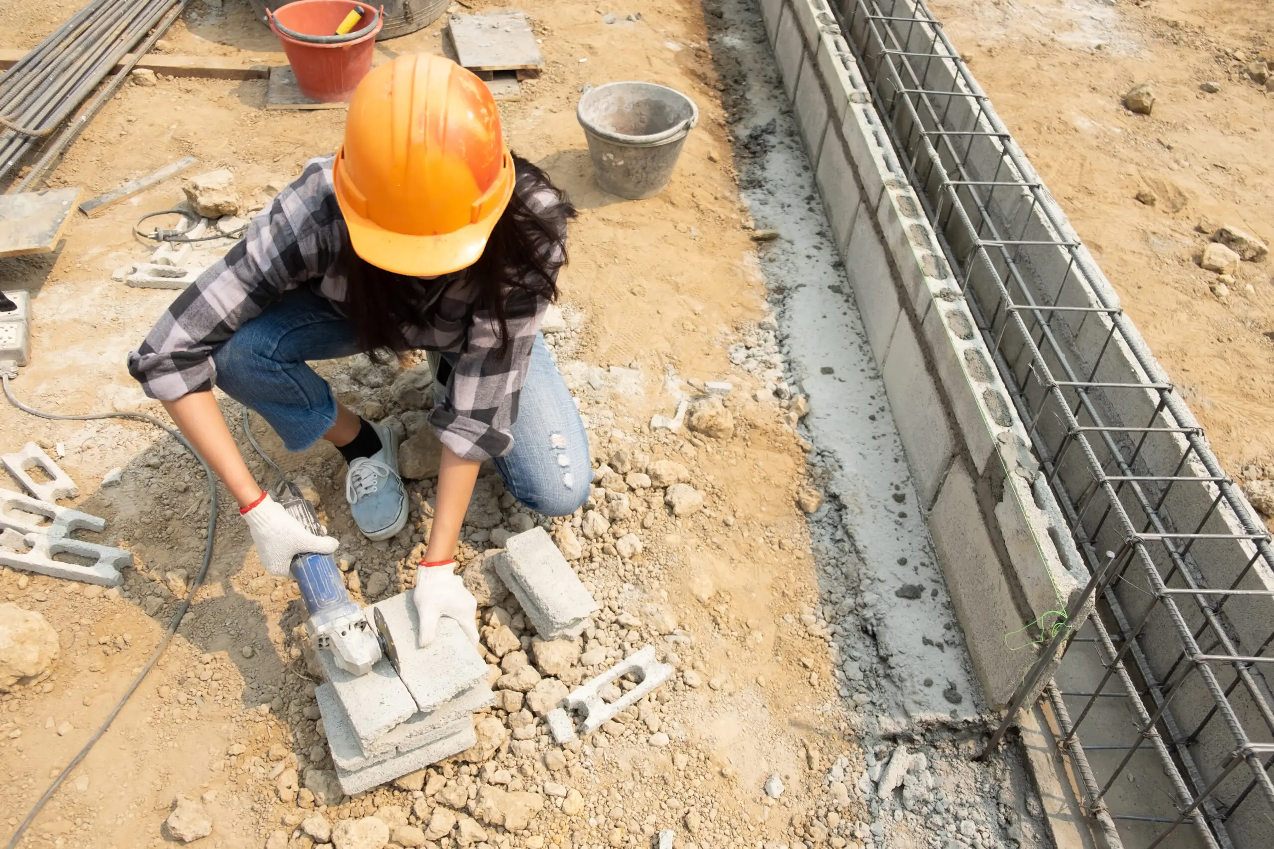 Round saw in the hands of the Builder, work on laying paving sla