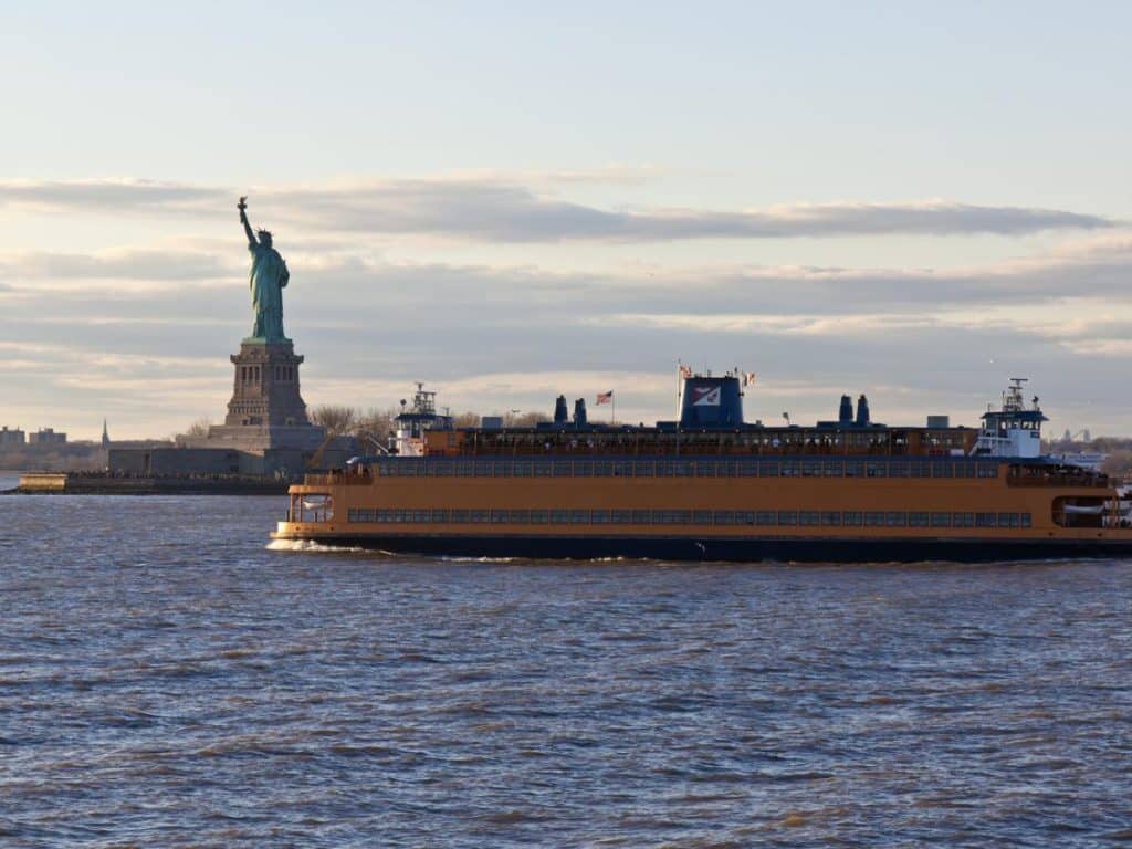 Staten Island Ferry cruises past the Statue of Liberty in New York City, NY